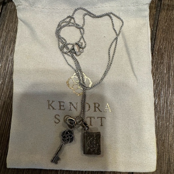Kendra Scott Silver Charm Necklace. Adjustable Length with key and book charm. - Picture 3 of 4
